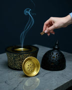 ZYVORA Noor — placing bakhoor onto the brass tray, cool ambient minimalism.